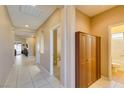 Bright hallway features neutral walls, tile flooring, and built-in storage, connecting various rooms at 5805 Hannah Brook St, North Las Vegas, NV 89081
