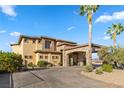 Luxury home with stone accents, a porte cochere, and lush landscaping offering curb appeal at 670 Du Fort Ave, Henderson, NV 89002