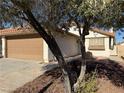 House exterior with a tree partially obscuring the view at 7588 Kalmalii Ave, Las Vegas, NV 89147