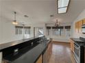 Spacious kitchen featuring a breakfast bar, tile floors, and stainless steel appliances at 840 Candido Garcia Ave, Henderson, NV 89015