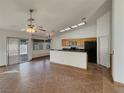 Open-concept living room with tile flooring and a sliding glass door to the backyard at 840 Candido Garcia Ave, Henderson, NV 89015