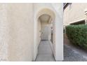 Covered entryway with arched alcove and decorative metal door at 8555 Burning Bridge Ct, Las Vegas, NV 89131