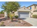 Attractive single-story home with desert landscaping, a mature tree, and a two-car garage at 8633 Sherwood Park Dr, Las Vegas, NV 89131