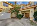 Front entrance with double doors and landscaping at 8870 S Tenaya Way, Las Vegas, NV 89113