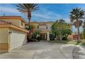 Two-story house with a three-car garage and landscaping at 8870 S Tenaya Way, Las Vegas, NV 89113