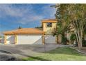 Three-car garage and front view of two-story house at 8870 S Tenaya Way, Las Vegas, NV 89113