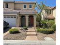 Charming exterior view of a two-story home with a well-manicured front yard and a welcoming entrance at 9022 Sosa Creek Ave, Las Vegas, NV 89149