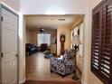 Inviting living room with a comfortable layout, showcasing tile flooring, and abundant natural light at 9022 Sosa Creek Ave, Las Vegas, NV 89149