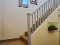 Beautiful staircase with gray railings and decorative wall art enhance the home's interior at 9022 Sosa Creek Ave, Las Vegas, NV 89149