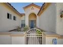 Inviting front entrance with a charming gate and a covered porch area, perfect for welcoming guests at 9843 Wonderful Day Dr, Las Vegas, NV 89148