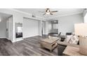 Spacious living room with wood-look floors, modern furniture, and natural light at , Las Vegas, NV 89117
