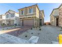 Two-story house with brown garage door and brick paver driveway at 10328 Apefly St, Las Vegas, NV 89141