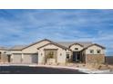 Charming single-story home features a three-car garage and inviting stone accents, set beneath a clear blue sky at 10420 Luella Ct, Las Vegas, NV 89143