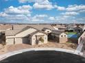 Charming single-story home with a three-car garage, neutral stucco, stone accents, and low-maintenance landscaping at 10420 Luella Ct, Las Vegas, NV 89143