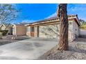 A single-story home features a two-car garage, low maintenance yard, and tile roof at 1106 Emerald Stone Ave, North Las Vegas, NV 89081