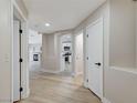 Hallway view showcasing archways, wood-look floors, and access to various rooms at 1106 Emerald Stone Ave, North Las Vegas, NV 89081