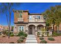 Two-story home with balcony, landscaping, and stone accents at 11262 Corsica Mist Ave, Las Vegas, NV 89135