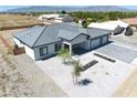 An aerial view of the house featuring a xeriscaped yard, and large paver driveway at 1691 Blackhorn St, Pahrump, NV 89048