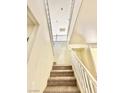 Carpeted staircase with white painted railing leads to the upper level at 1838 Fighting Falcon Ln, North Las Vegas, NV 89031