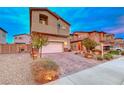 Two-story house with a landscaped front yard and attached garage, on a quiet street at 200 Denette Ln, North Las Vegas, NV 89031