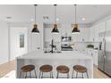 Bright kitchen with a large island, quartz countertops, and stainless steel appliances at 2384 Ridgeline Wash St, Las Vegas, NV 89138