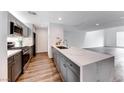 Modern kitchen with gray cabinets, quartz countertops, and stainless steel appliances at 247 Dougram Ave, Las Vegas, NV 89101