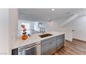 Modern kitchen island with white quartz countertop and gray cabinets at 247 Dougram Ave, Las Vegas, NV 89101