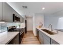 Modern kitchen with gray cabinets, quartz countertops, and stainless steel appliances at 247 Dougram Ave, Las Vegas, NV 89101