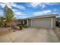 Home's exterior showcasing a garage and a nicely landscaped front yard at 250 Tonalea Ave, Henderson, NV 89015