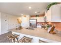 Modern kitchen with stainless steel appliances and island at 2550 Petunia Garden Ave # 219, North Las Vegas, NV 89081