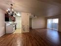 Open living room and kitchen with wood-look floors at 2606 S Durango Dr # 172, Las Vegas, NV 89117