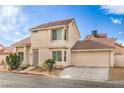 Inviting two story home with neutral stucco, well manicured shrubs, tile roof, and attached two car garage at 2727 Scotch Heather St, Las Vegas, NV 89142