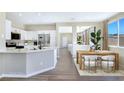 Stylish kitchen and dining area with white cabinetry, stainless steel appliances, and a seamless flow for entertaining at 283 Fancrest St, Henderson, NV 89052