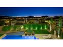 Night view of homes with city lights in the background at 3 Hilltop Crest St, Henderson, NV 89011