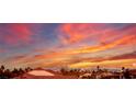 Striking sunset view over rooftops, showcasing vibrant orange and pink hues at 3146 Surf Spray St, Las Vegas, NV 89117