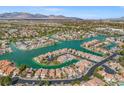 Stunning aerial view of a lakefront community with custom homes, lush landscaping, and mountain backdrop at 3305 Cutty Sark St, Las Vegas, NV 89117