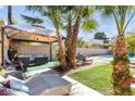 Landscaped backyard with patio furniture under a pergola at 3398 El Camino Real, Las Vegas, NV 89121