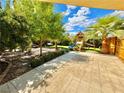 Spacious backyard with playset, patio, and lush landscaping at 3398 El Camino Real, Las Vegas, NV 89121