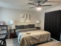 A well-lit bedroom featuring a ceiling fan, bed, and matching nightstands at 3625 Winner Dr, Las Vegas, NV 89120