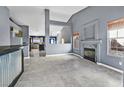 Open living room with a view of the kitchen and fireplace at 3757 Grand Viewpoint Ct, Las Vegas, NV 89147