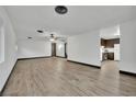 Open-concept living room with wood-look floors seamlessly flowing into a modern kitchen space at 4151 Calimesa St, Las Vegas, NV 89115