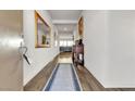 Bright entryway with hardwood floors, decorative mirrors, and an antique console table at 4267 E Highvale Ct, Pahrump, NV 89061