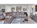 Comfortable living room with a sectional sofa and a stylish coffee table atop a striped rug at 4267 E Highvale Ct, Pahrump, NV 89061