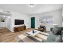 Spacious living room featuring wood floors and ample natural light at 6520 Evergreen Ave, Las Vegas, NV 89107