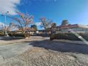 Complex view showing building, landscaping, and parking at 671 Bourbon St # H2, Pahrump, NV 89048