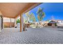 Covered patio with built-in grill, fireplace, and grassy area at 752 Golden Sedum Dr, Henderson, NV 89011