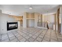 Open living room with a fireplace, tile flooring and kitchen views at 752 Golden Sedum Dr, Henderson, NV 89011