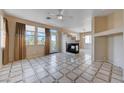 Spacious living room with fireplace, tile floors, and lots of natural light at 752 Golden Sedum Dr, Henderson, NV 89011