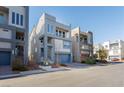 Row of modern townhouses with rooftop decks and attached garages at 8125 Monsoon Bay St, Las Vegas, NV 89113