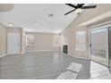 Bright and airy living room featuring tile floors, a fireplace, and sliding glass doors to the backyard at 8201 Lake Isle Ct, Las Vegas, NV 89145